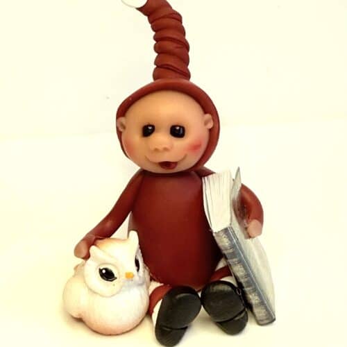 Nisse med bog og fugl